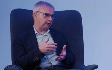 Man sitting in a chair being interviewed