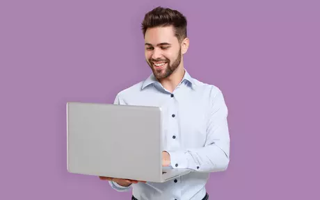 men with a laptop in his hands smiling