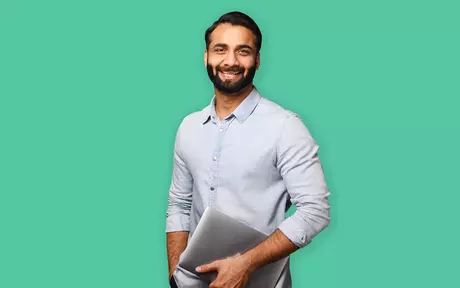 men smiling and caring a laptop