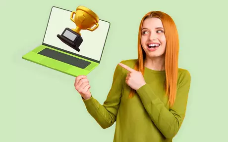 woman pointing to a laptop with an award