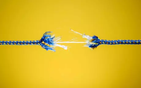 breaking rope on yellow background